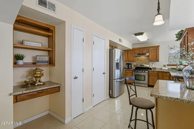 a view of a kitchen with dining table and chairs