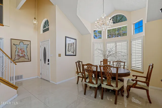 a view of a dining room with furniture and a chandelier