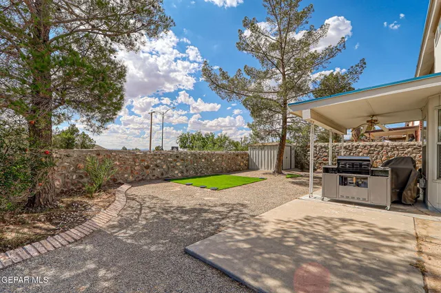 a view of a backyard with patio