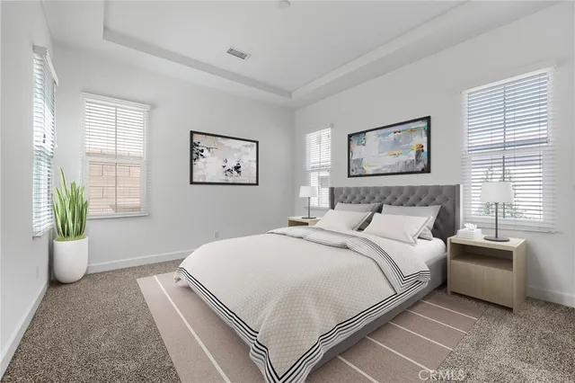 a bedroom with a bed and painting on the wall