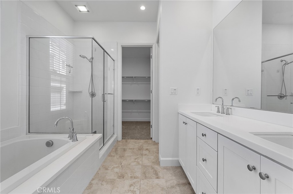 82 Meander Irvine, CA 92620 - Photo 14 of 32 a spacious bathroom with a tub sink shower and mirror