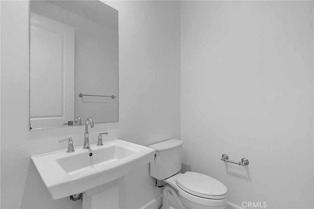 82 Meander Irvine, CA 92620 - Photo 16 of 32 a bathroom with a sink a toilet and mirror