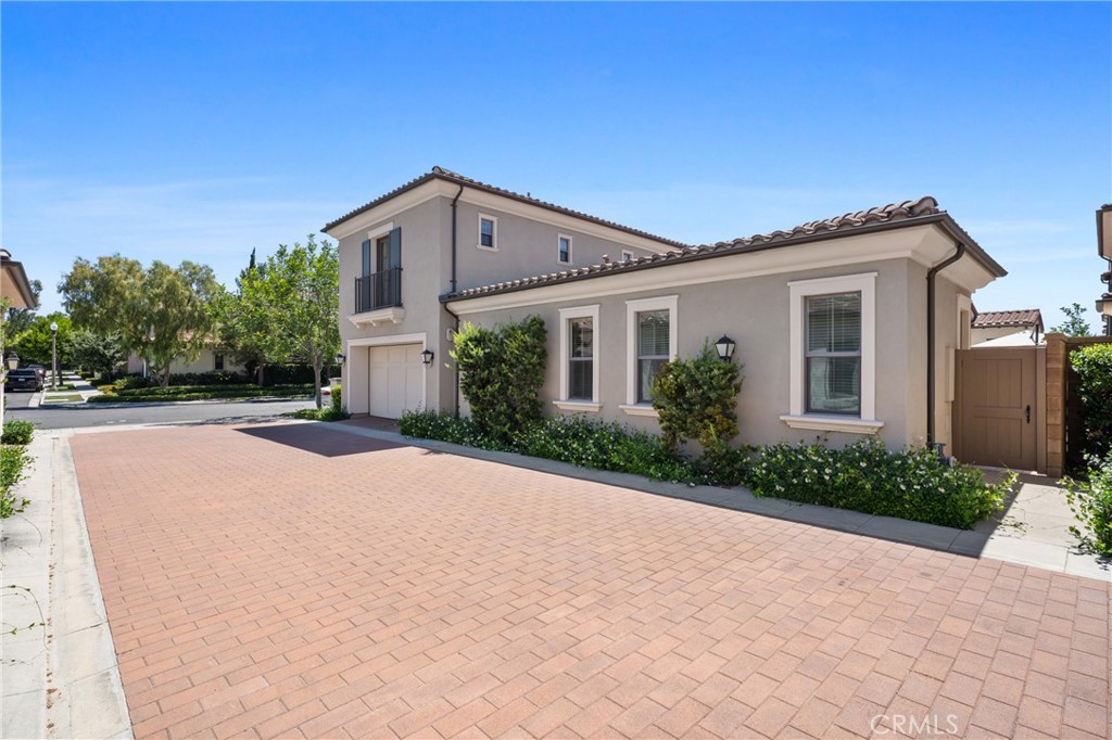 82 Meander Irvine, CA 92620 - Photo 28 of 32 a front view of a house with a yard and a garage