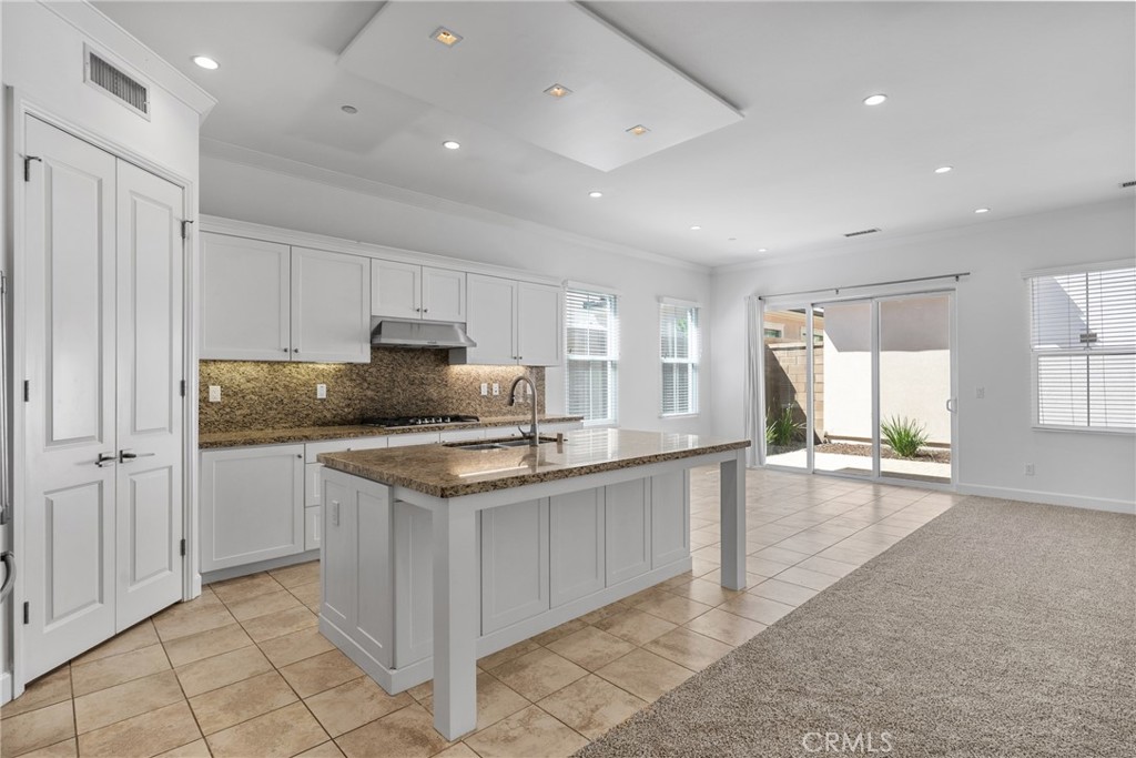 82 Meander Irvine, CA 92620 - Photo 3 of 32 a kitchen with a sink window and cabinets