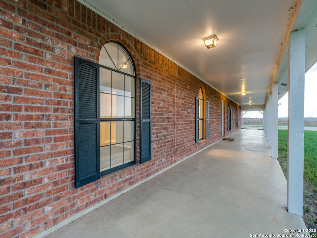 315 Simon Road Pleasanton, TX 78064 - Photo 11 of 37 a view of an empty room with a balcony