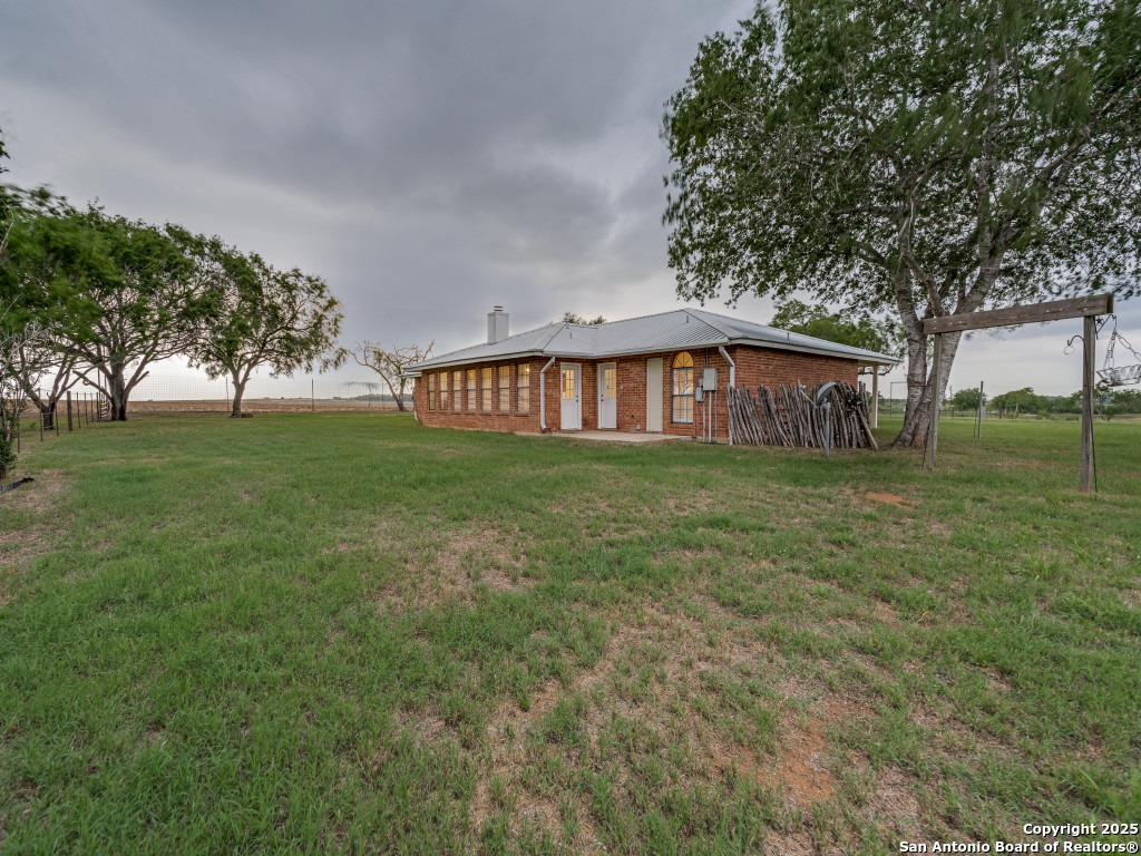 315 Simon Road Pleasanton, TX 78064 - Photo 26 of 37 a view of a house with a yard