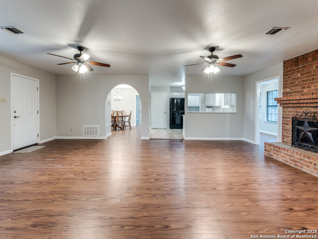 315 Simon Road Pleasanton, TX 78064 - Photo 7 of 37 wooden floor in an empty room with a window
