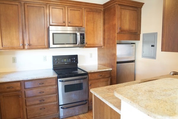 1091 Boylston Street, Unit 36 Boston, MA 02215 - Photo 4 of 7 a kitchen with granite countertop cabinets stainless steel appliances and a counter space