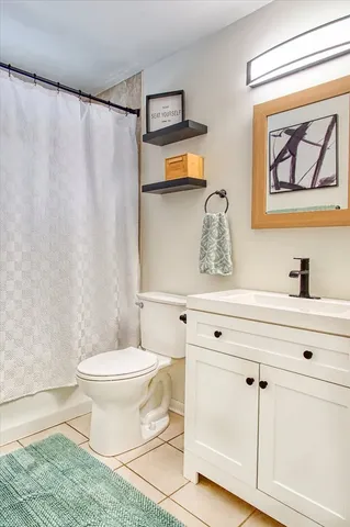 a bathroom with a toilet a sink and a mirror