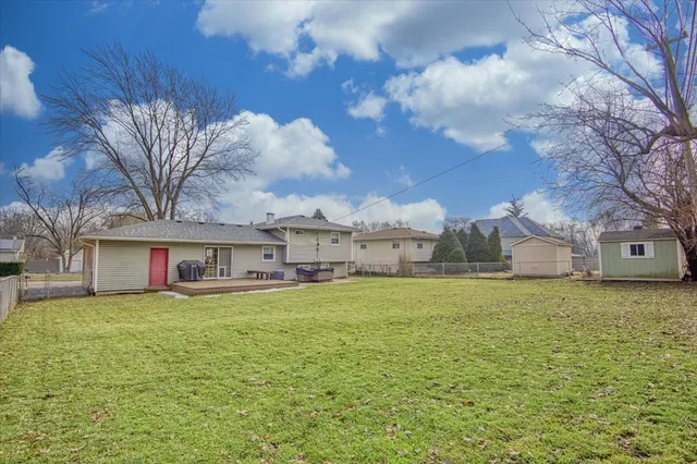 a large house with a big yard and large trees