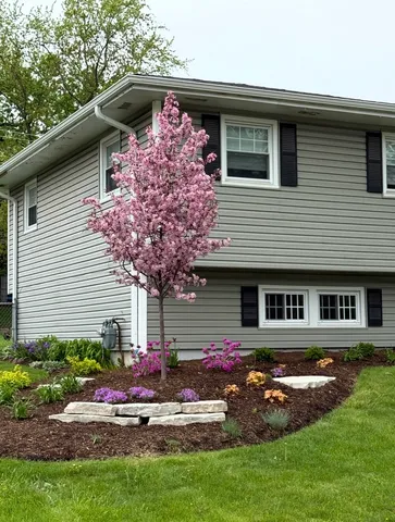 a front view of a house with garden