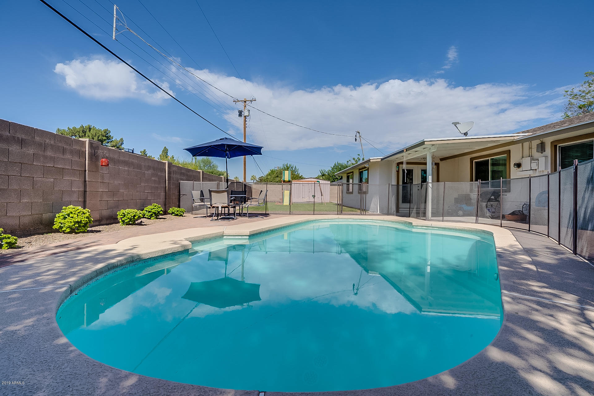 4847 East Osborn Road Phoenix, AZ 85018 - Photo 54 of 61 a view of a white house with a swimming pool