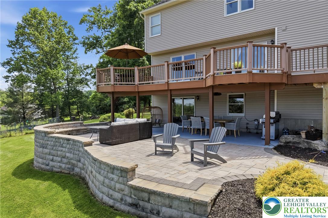 115 West Butternut Road Hellertown, PA 18055 - Photo 74 of 97 An inviting outdoor living area with a tiered patio and elevated deck, perfect for entertaining.