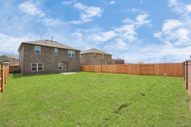 a view of a kitchen with a refrigerator and a sink