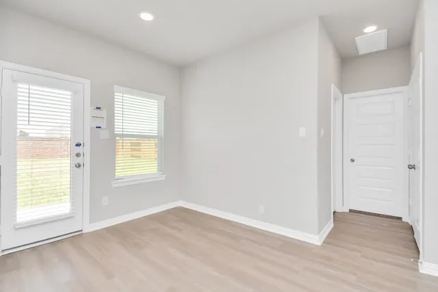 a bathroom with a bathtub shower sink vanity mirror and toilet