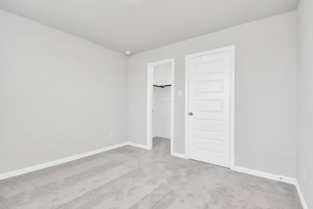 an empty room with closet area