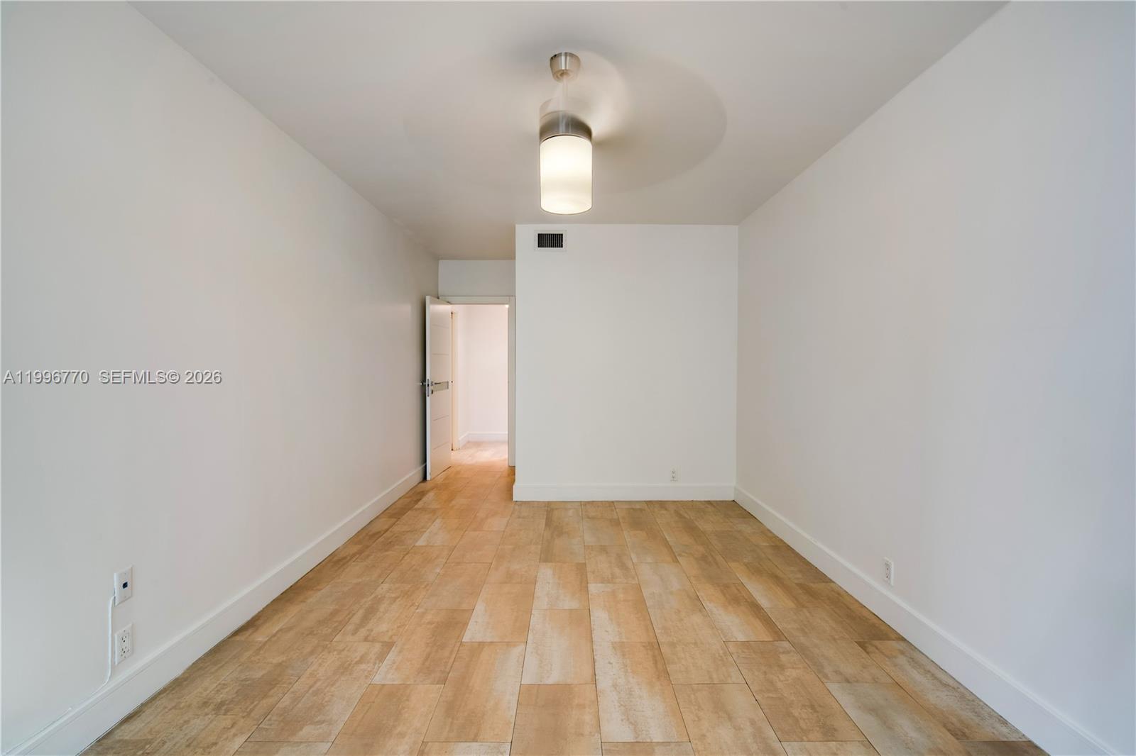 181 Crandon Boulevard, Unit 104 Key Biscayne, FL 33149 - Photo 14 of 28 a view of empty room with wooden floor