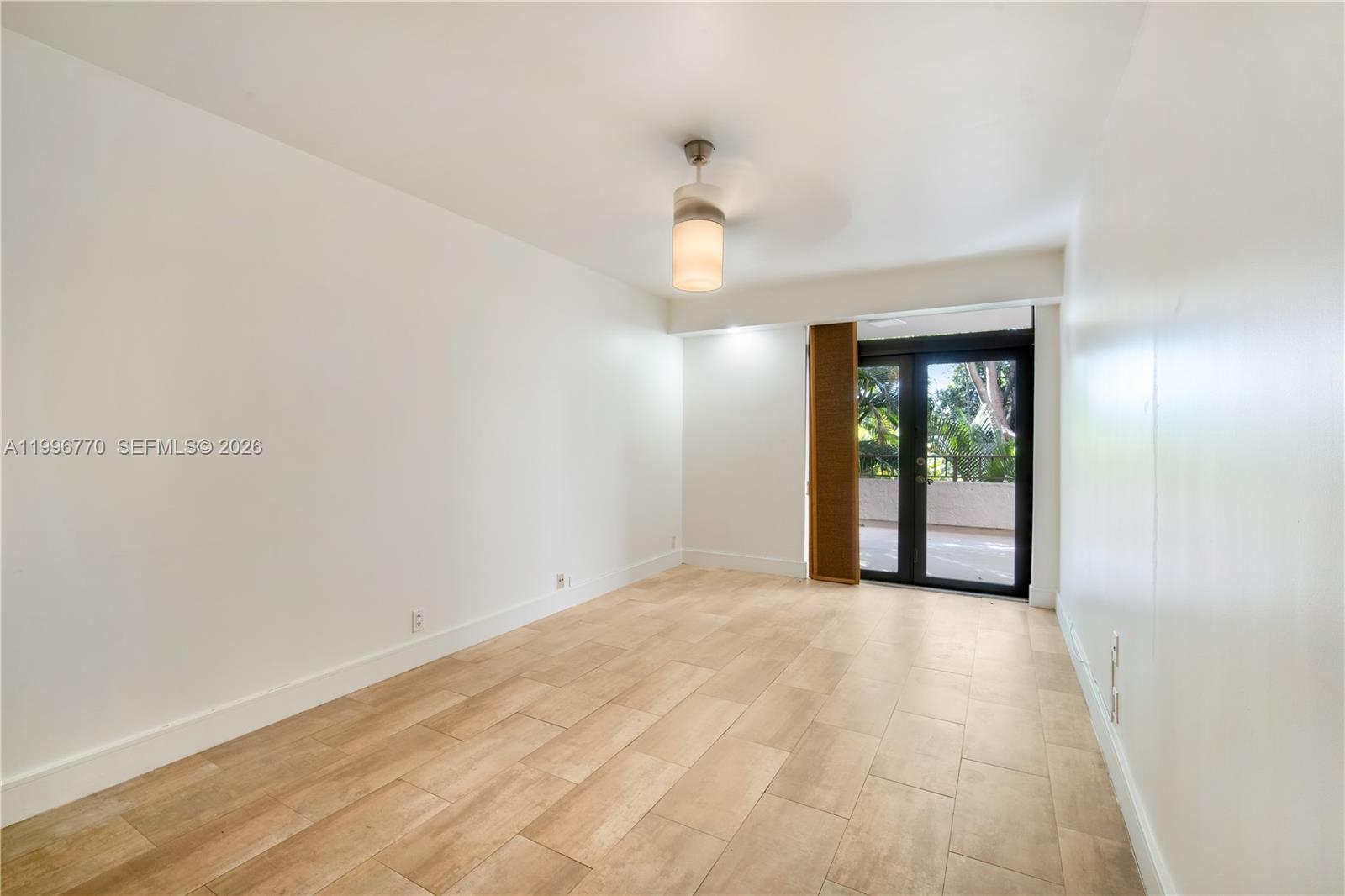 181 Crandon Boulevard, Unit 104 Key Biscayne, FL 33149 - Photo 16 of 28 a view of an empty room with glass door