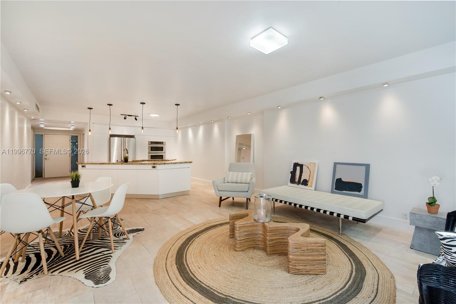 181 Crandon Boulevard, Unit 104 Key Biscayne, FL 33149 - Photo 2 of 28 a living room with furniture and a wooden floor