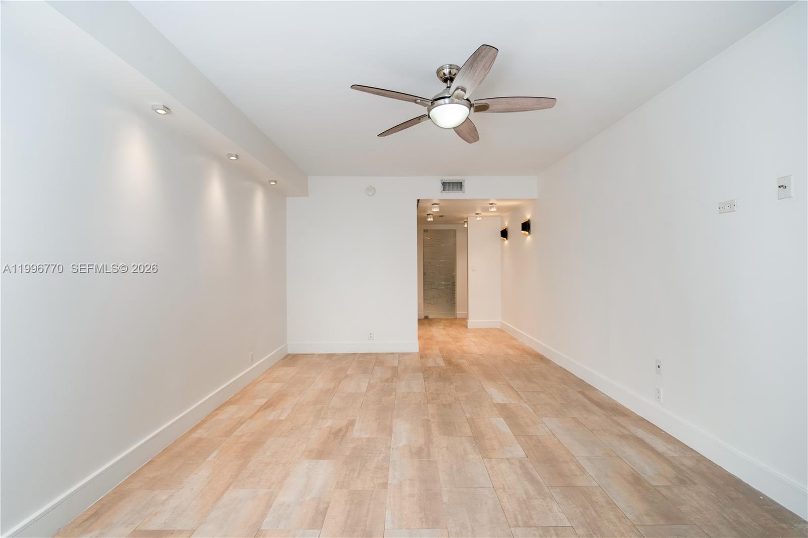 181 Crandon Boulevard, Unit 104 Key Biscayne, FL 33149 - Photo 22 of 28 a view of an empty room with wooden floor