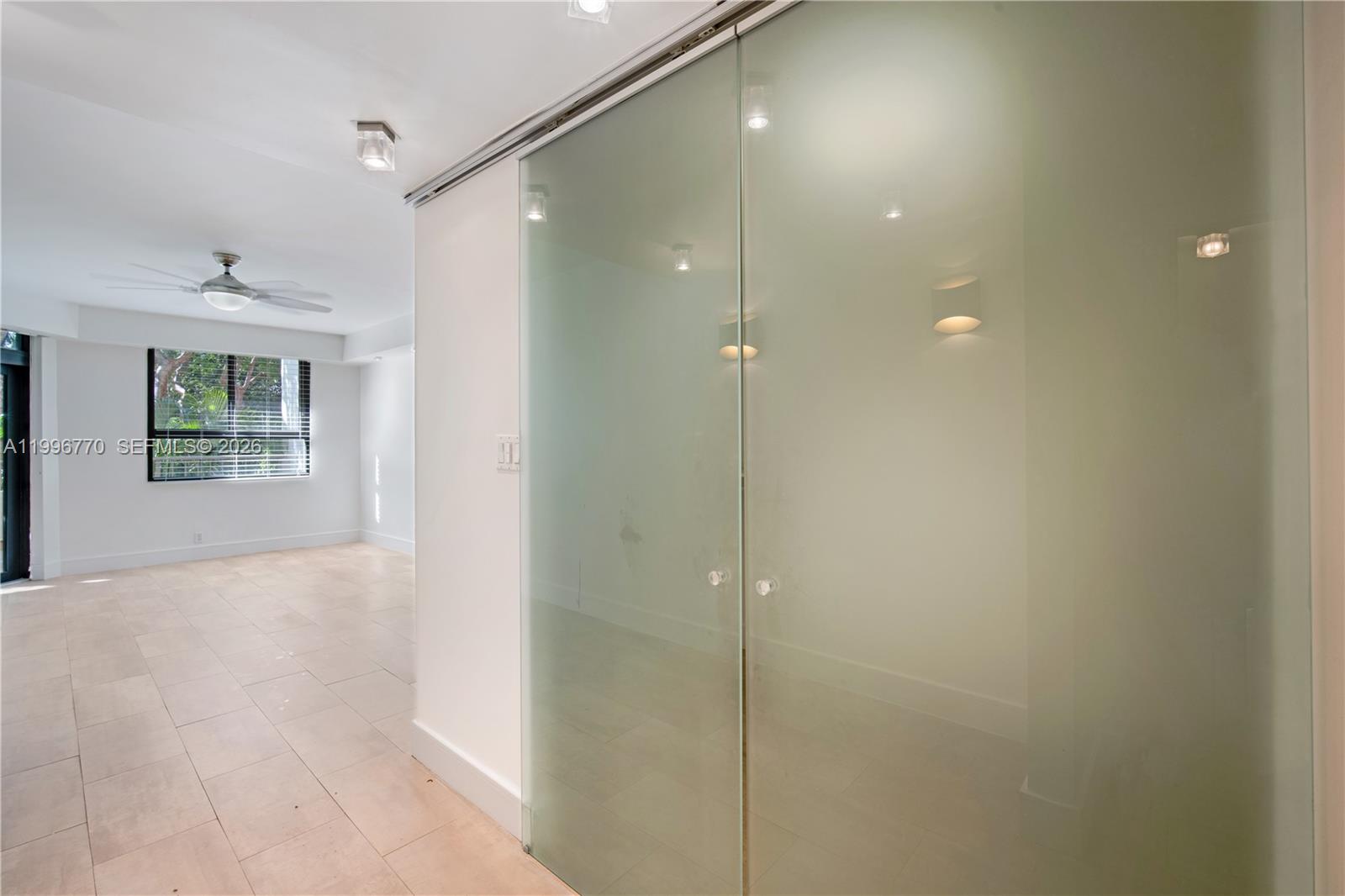 181 Crandon Boulevard, Unit 104 Key Biscayne, FL 33149 - Photo 25 of 28 a view of a bathroom from a hallway