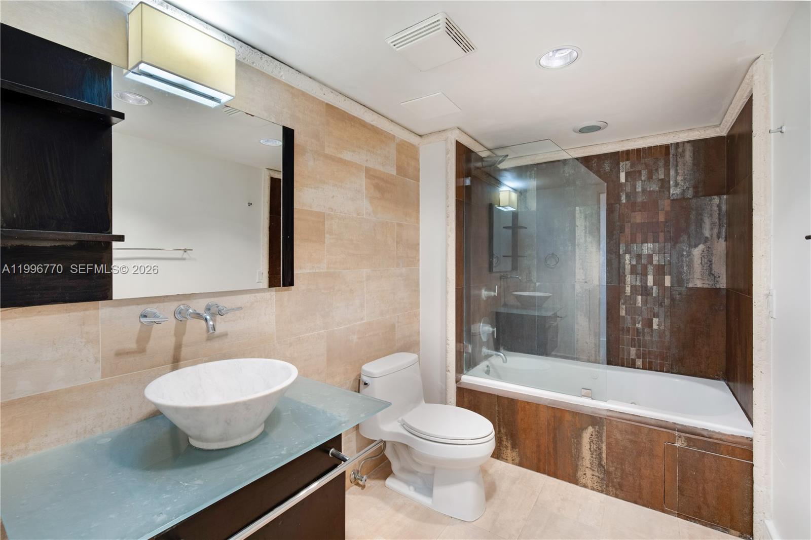 181 Crandon Boulevard, Unit 104 Key Biscayne, FL 33149 - Photo 26 of 28 a bathroom with a toilet a sink and a bathtub