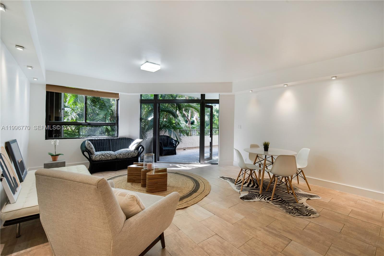 181 Crandon Boulevard, Unit 104 Key Biscayne, FL 33149 - Photo 3 of 28 a living room with furniture and a large window