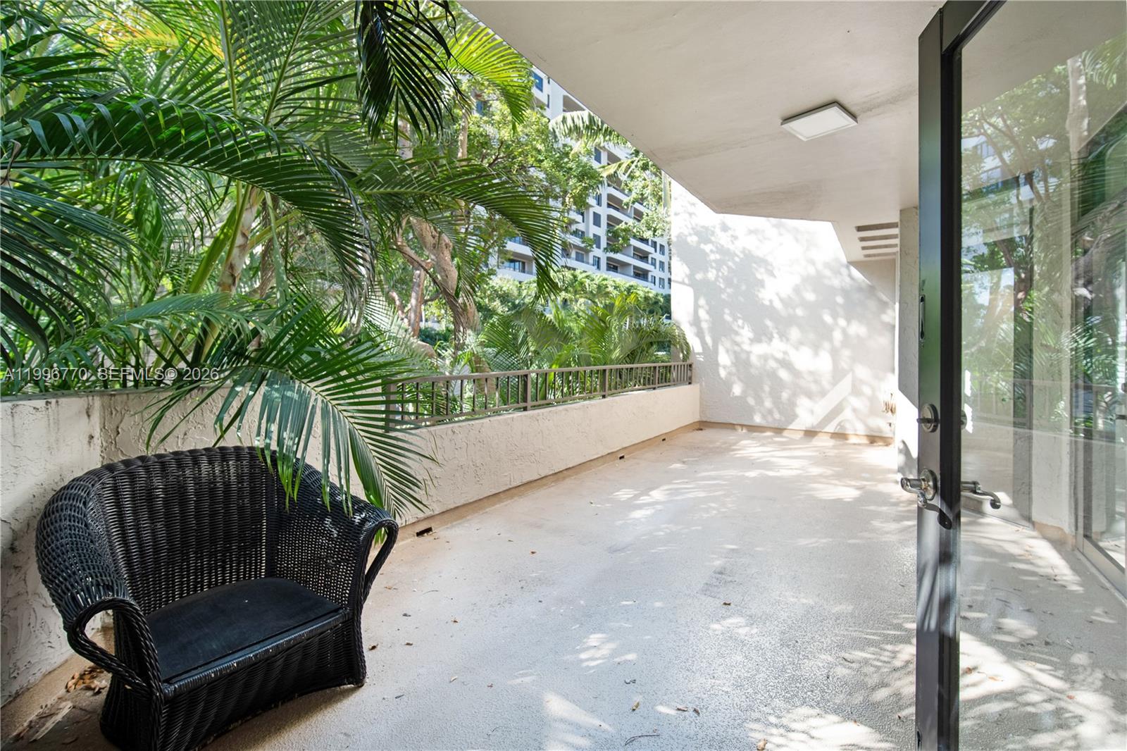 181 Crandon Boulevard, Unit 104 Key Biscayne, FL 33149 - Photo 9 of 28 a view of a two chair in the patio