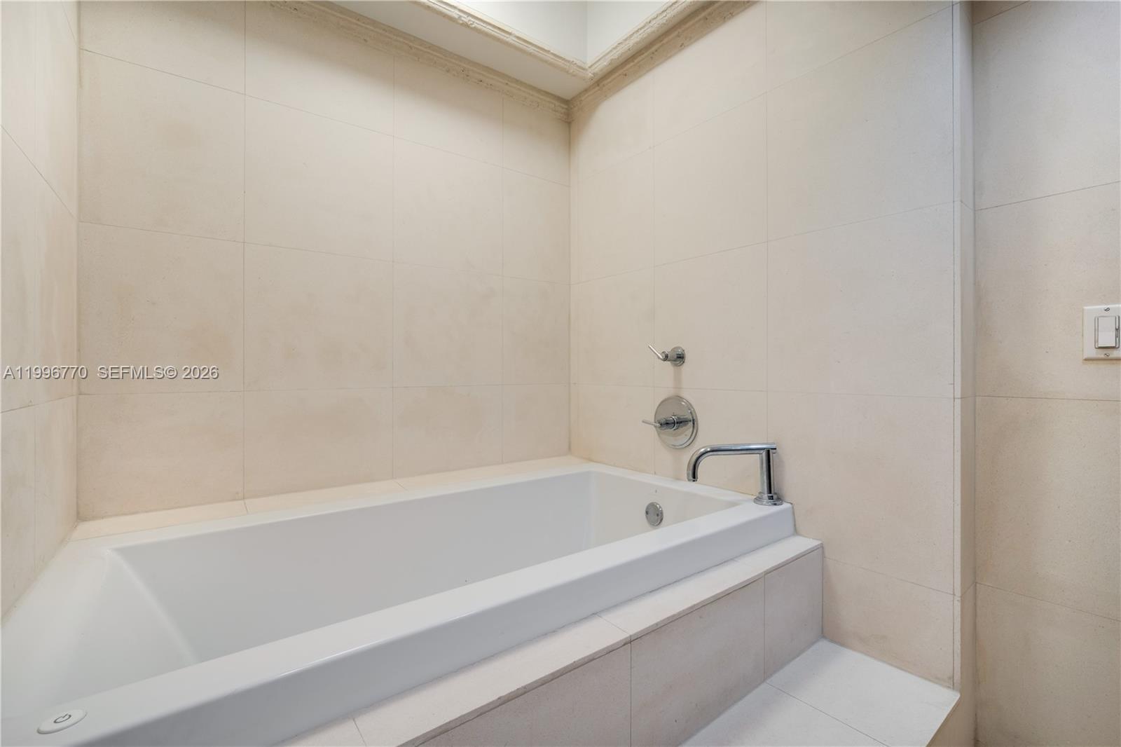 181 Crandon Boulevard, Unit 104 Key Biscayne, FL 33149 - Photo 10 of 28 a white bath tub and shower