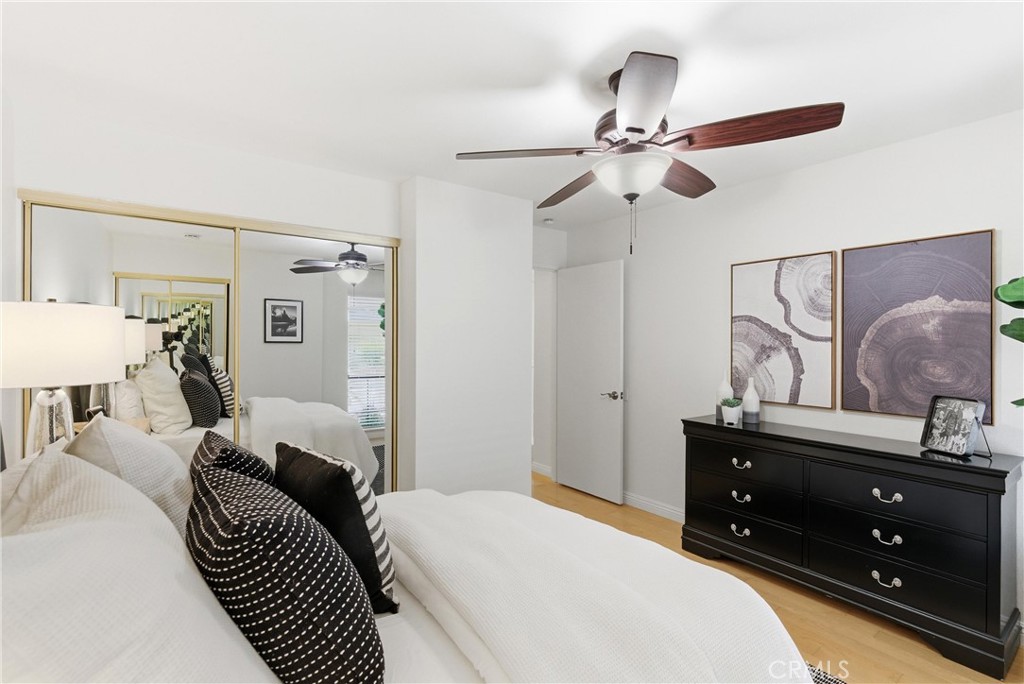 7735 Briarglen Loop, Unit I Stanton, CA 90680 - Photo 20 of 32 a bedroom with a bed and a dresser