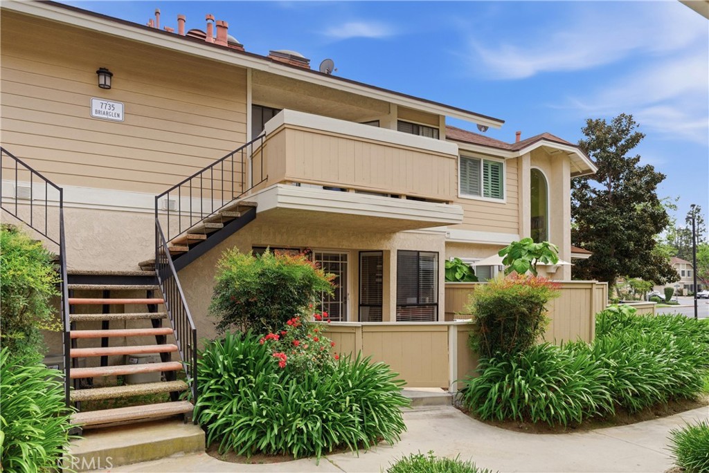 7735 Briarglen Loop, Unit I Stanton, CA 90680 - Photo 2 of 32 a front view of a house with a garden