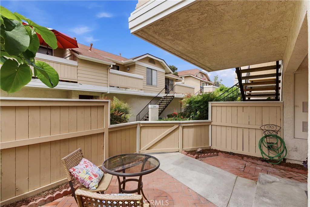 7735 Briarglen Loop, Unit I Stanton, CA 90680 - Photo 4 of 32 a backyard of a house with barbeque oven table and chairs