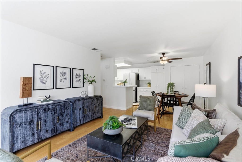 7735 Briarglen Loop, Unit I Stanton, CA 90680 - Photo 6 of 32 a living room with furniture and wooden floor