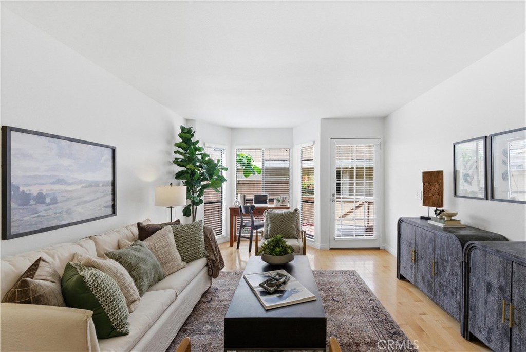 7735 Briarglen Loop, Unit I Stanton, CA 90680 - Photo 7 of 32 a living room with furniture couches and a flat screen tv