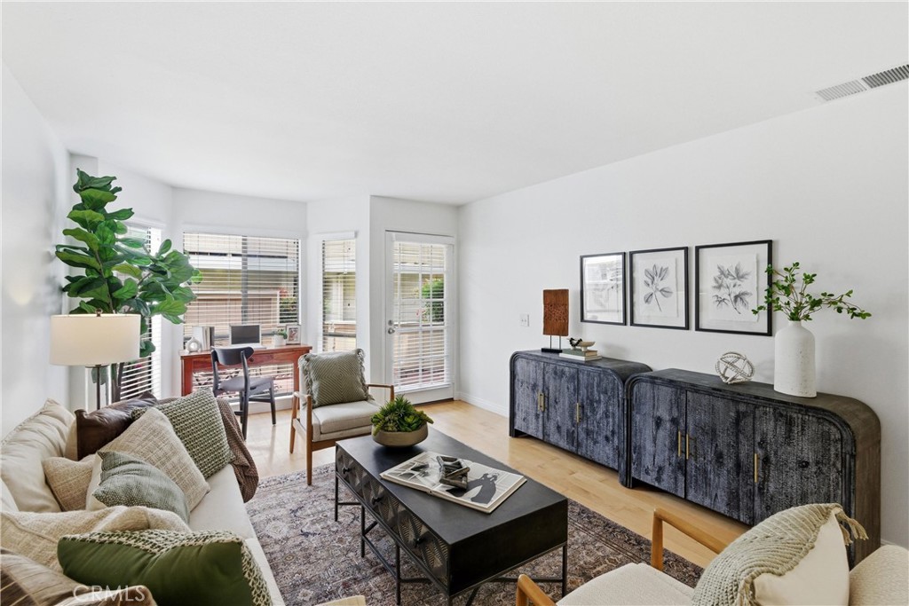 7735 Briarglen Loop, Unit I Stanton, CA 90680 - Photo 8 of 32 a living room with furniture and a wooden floor