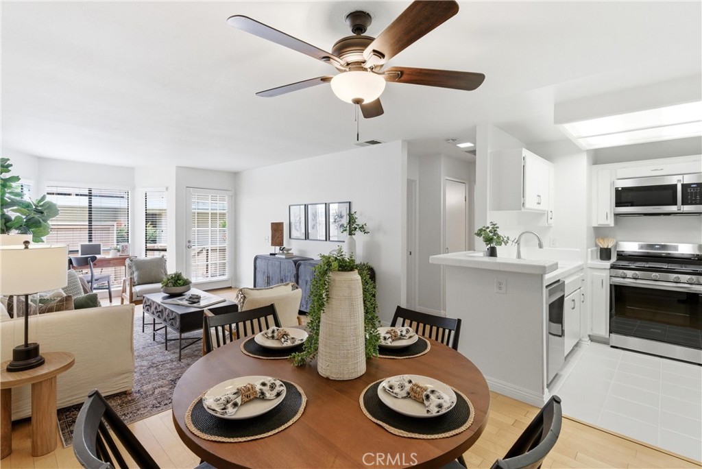 7735 Briarglen Loop, Unit I Stanton, CA 90680 - Photo 10 of 32 a kitchen with a dining table and chairs