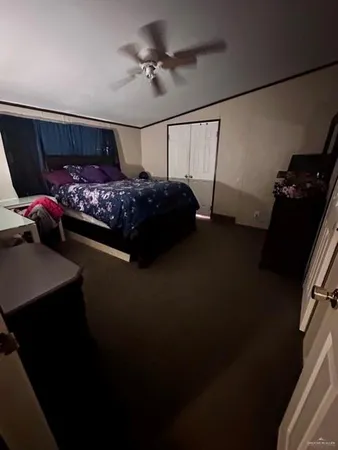 a bed room with a bed window and a flat screen tv