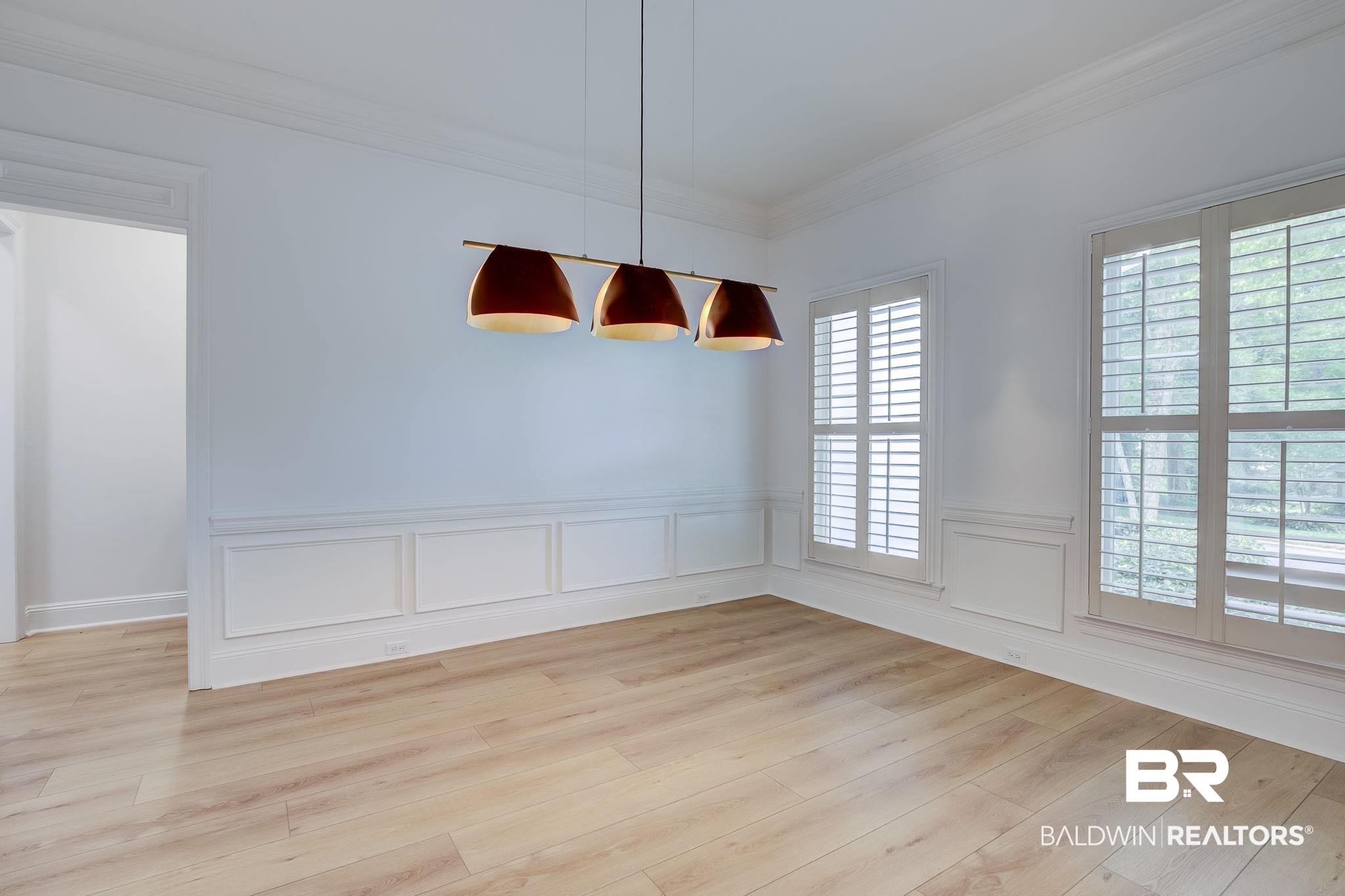 105 High Pines Ridge Fairhope, AL 36532 - Photo 37 of 97 Unfurnished dining area with ornamental molding, light wood-type flooring, and a wainscoted wall