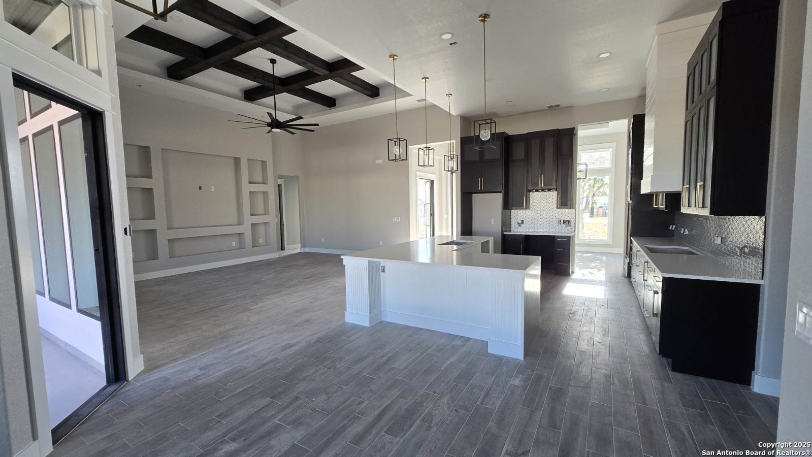 699 James Way Castroville, TX 78009 - Photo 11 of 31 a view of a living room a refrigerator and a fireplace