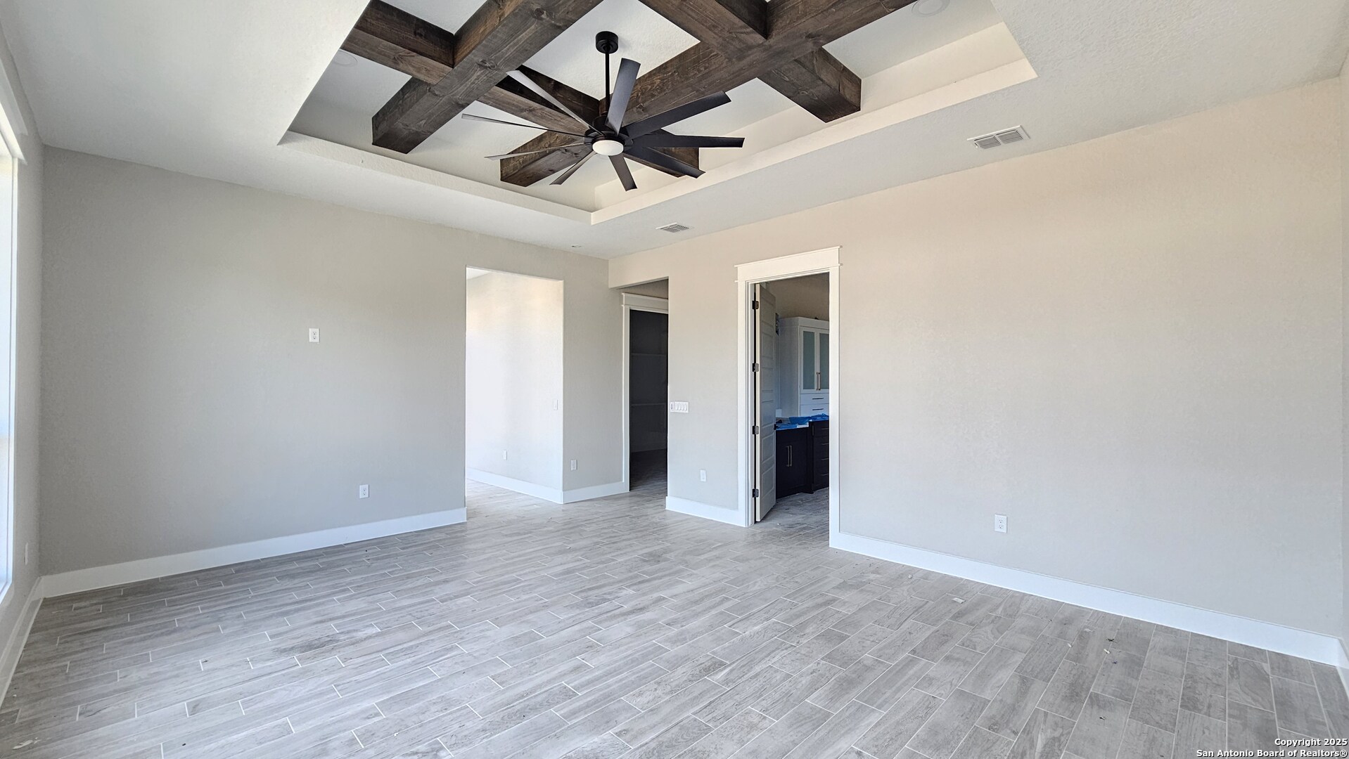 699 James Way Castroville, TX 78009 - Photo 13 of 31 an empty room with wooden floor and ceiling fan