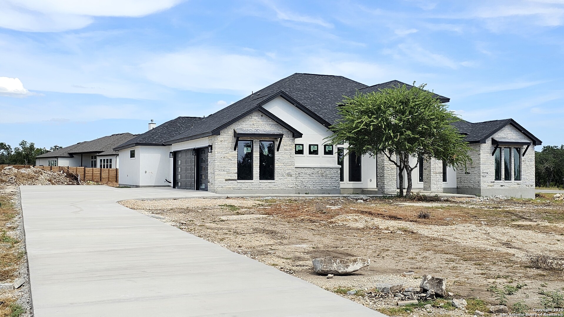 699 James Way Castroville, TX 78009 - Photo 2 of 31 a front view of a house with a yard and garage