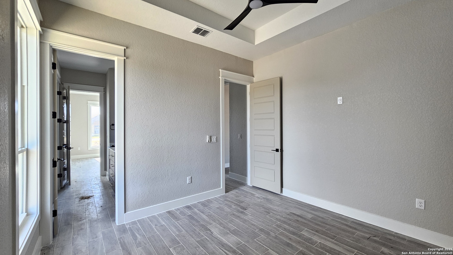 699 James Way Castroville, TX 78009 - Photo 25 of 31 an empty room with wooden floor and a ceiling fan