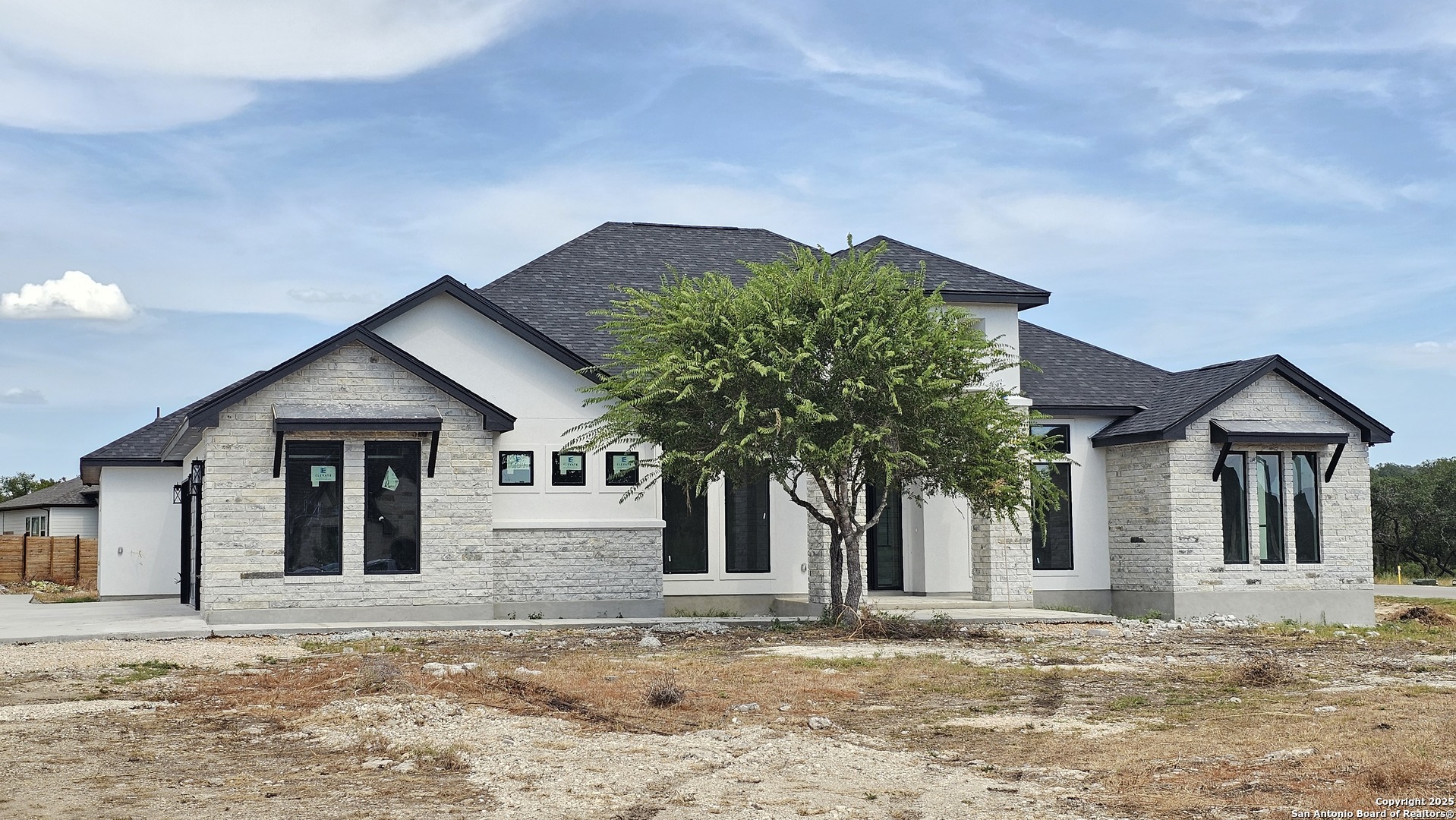 699 James Way Castroville, TX 78009 - Photo 3 of 31 a house with a tree in front of it
