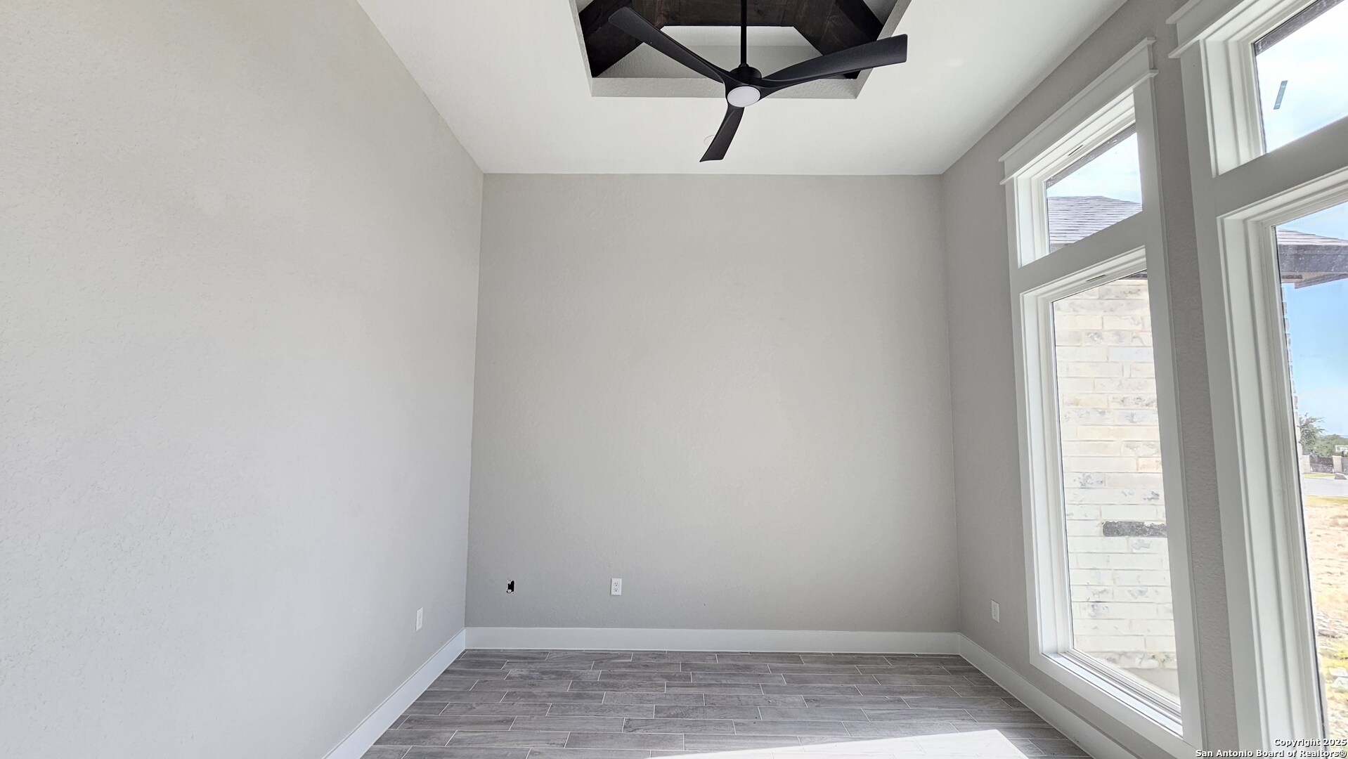 699 James Way Castroville, TX 78009 - Photo 4 of 31 a view of small space with wooden floor and windows