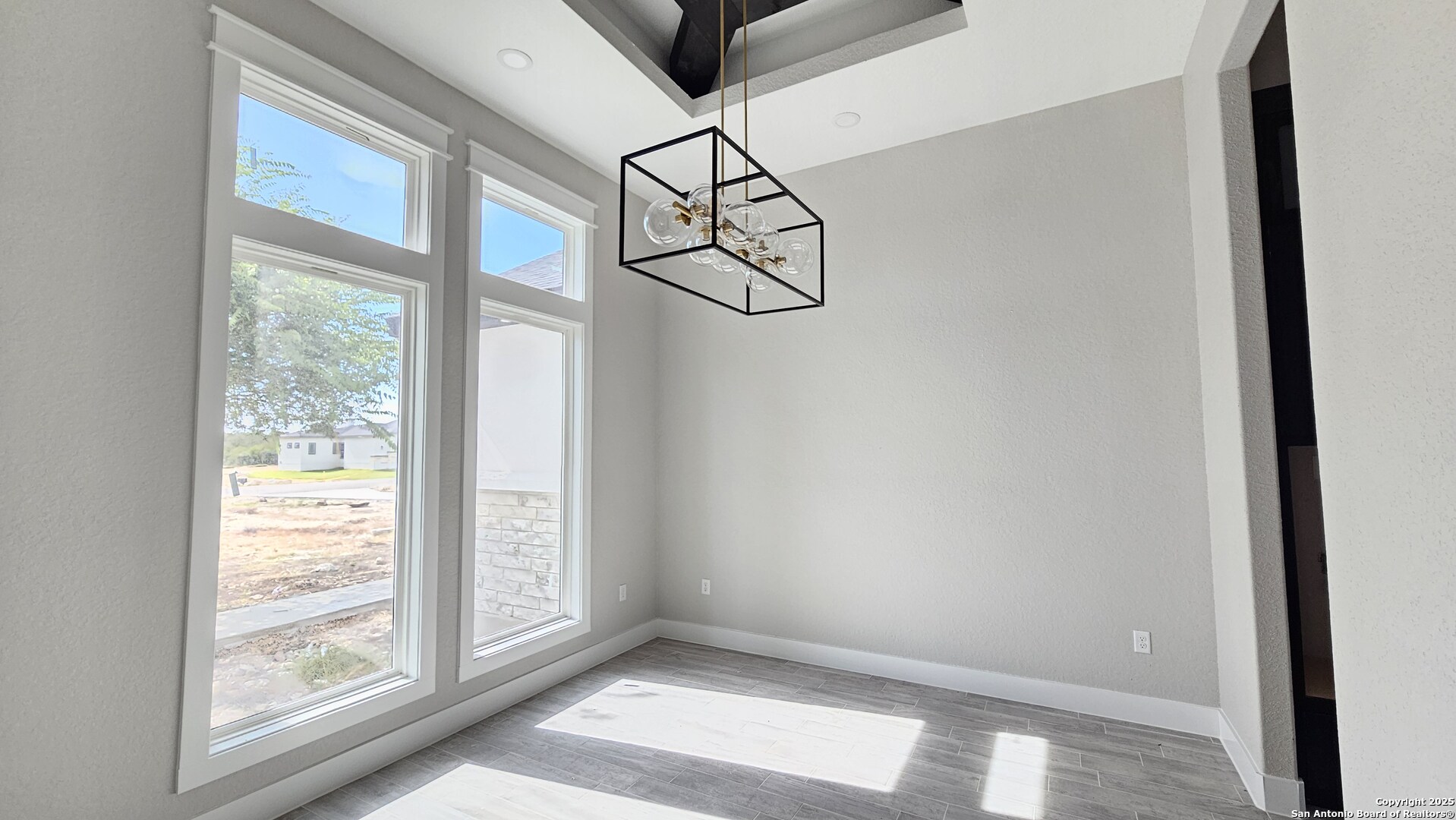 699 James Way Castroville, TX 78009 - Photo 5 of 31 a view of empty room with window and wooden floor