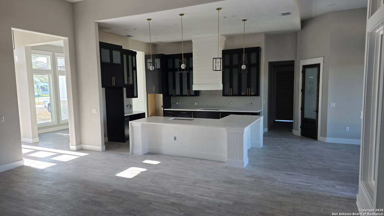 699 James Way Castroville, TX 78009 - Photo 9 of 31 a large bathroom with a large mirror vanity and shower