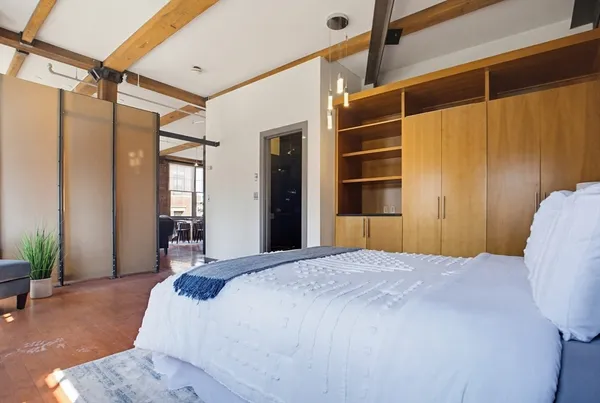 a bedroom with a bed and a window