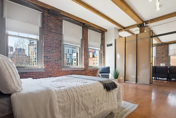 a bedroom with a large bed and a large window