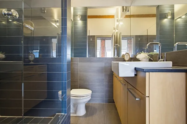 a bathroom with a toilet a sink and shower