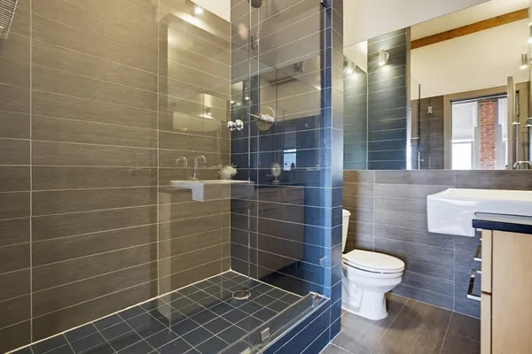 a bathroom with a toilet and a shower